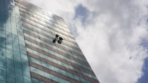 two people on a high-rise cleaning the windows