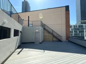 Sun-drenched rooftop terrace with sharp shadows, reflecting how clean surroundings boost mood and clarity.