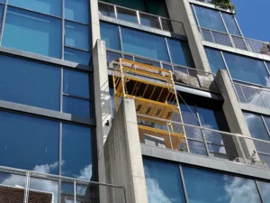 Modern Midtown façade with gleaming windows reflecting blue sky after professional cleaning.