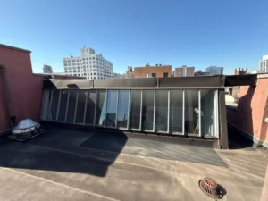 Angled skylight installation with limited access on NYC building rooftop